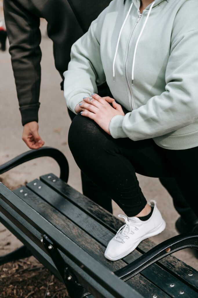 Woman exercising outdoors with a trainer, focusing on well-being and fitness.